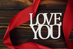 Top view of wooden surface with festive red cloth. Conception of valentine's day photo