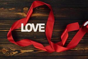 Top view of wooden surface with festive red cloth. Conception of valentine's day photo