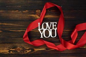 Top view of wooden surface with festive red cloth. Conception of valentine's day photo