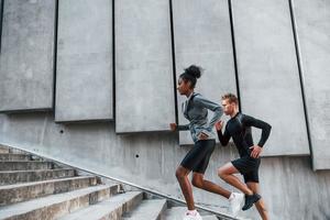 European man and african american woman in sportive clothes have workout together photo