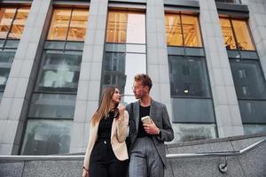 Woman and man in the town at daytime. Well dressed people photo