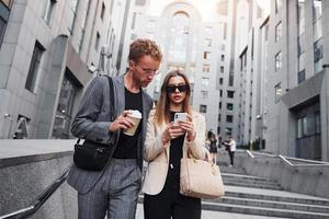 Woman and man in the town at daytime. Well dressed people photo
