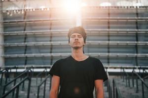 Portrait of young man in sportive clothes that have workout outdoors at daytime photo