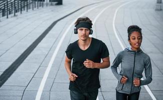 European man and african american woman in sportive clothes have workout together photo