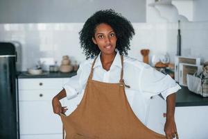 Young african american woman with curly hair indoors at home photo