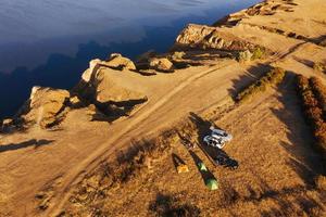 Tourists, car and camp. Aerial view of majestic landscapes of Jarilgach island in Ukraine photo