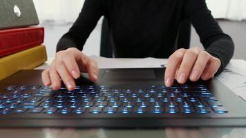 Woman fingers typing on laptop keyboard video