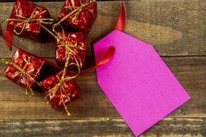 decorative christmas elements next to card with red ribbon and space to write photo