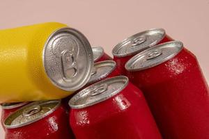 Cold red soda cans with a yellow one for conceptual use photo