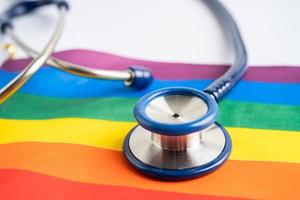 stethoscope on rainbow flag background, symbol of LGBT pride month  celebrate annual in June social, symbol of gay, lesbian, bisexual, transgender, human rights and peace. photo