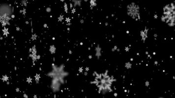 Patterned snowflakes falling with a swirl in the frame on a black background