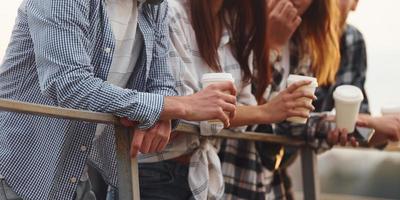 Close up view. Group of young cheerful friends that is outdoors having fun together photo