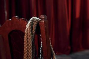 Close up view of knot that hanging on the red chair on the stage of theater photo