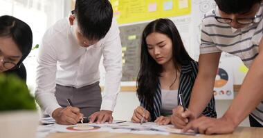 Slide moving of business employee writing and editing the information in meeting room. Female and male colleagues checking document while standing at office. video