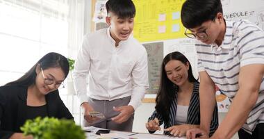 Side view of business employee explaining and editing the information in meeting room. Female and male colleagues checking document while standing at office. video