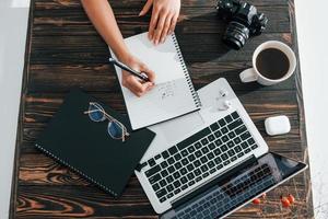 Young female freelancer working indoors in the office at daytime photo