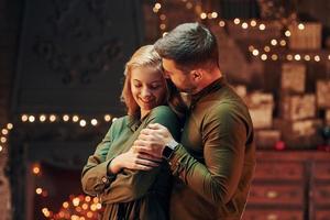 Standing and embracing each other. Young lovely couple have romantic dinner indoors together photo