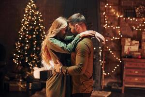 Standing and embracing each other. Young lovely couple have romantic dinner indoors together photo