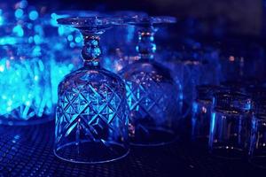 Close up view of row of empty glasses on table in the pub indoors photo