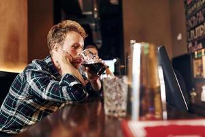 Group of people together indoors in the pub have fun at weekend time photo