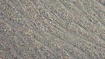 Wet sand water stock texture loop. Summer beach background. video