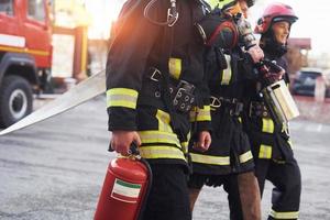 Group of firefighters in protective uniform that is on station photo