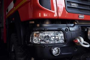 Close up view of red modern fire truck. Front part of vehicle photo
