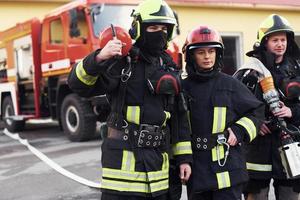 Group of firefighters in protective uniform that is on station photo