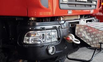 Close up view of front part of red fire truck. Natural lighting photo