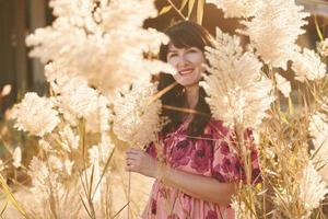 Happy mature woman is outdoors enjoying her vacation at sunny daytime photo