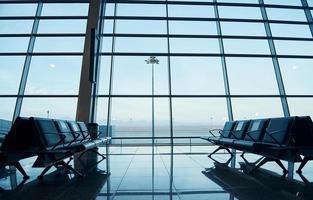 Interior of modern airport at daytime with no people inside it photo