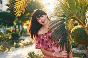 Happy mature woman is outdoors enjoying her vacation at sunny daytime photo