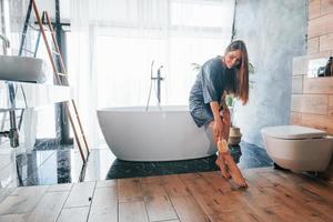 Beautiful young woman have free time at home in the bath photo