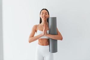 Young caucasian woman with slim body shape is indoors at daytime photo