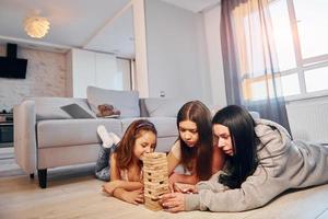 Female lesbian couple with little daughter spending time together at home photo