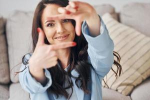 Domestic room. European woman in fashionable stylish clothes is posing indoors photo