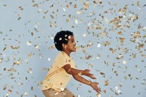 Happy little african american kid have fun indoors at birthday party photo