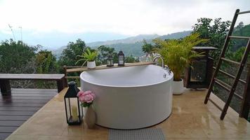 outdoor bath tub with beautiful mountain hill view background video