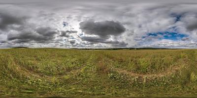 full seamless 360 hdri panorama view among farming fields with clouds in overcast sky in equirectangular spherical projection, ready for VR AR virtual reality content photo