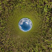 blue hole sphere little planet inside green grass round frame background photo