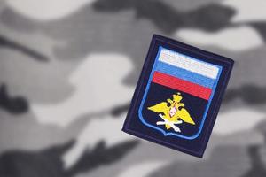 Military camp, chevron of the Russian army on camouflage fabric. soft blurred background. photo