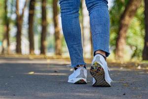 steps of Asian women While walking on the streets of the park, concept steps towards the goal. soft and selective focus. photo