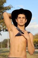 Sexy Cowboy shirtless and in black cowboy hat. photo