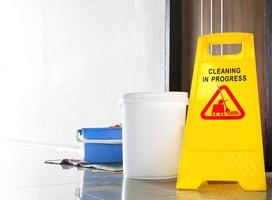 Close up yellow warning sign with message Cleaning in progress photo