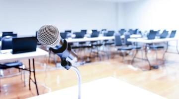 Close up microphone with laptop on table background in seminar room photo