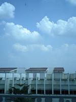 Photo of blue sky clouds over an old building