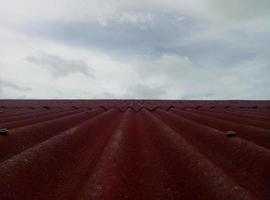 Closeup of red roof cover. Tiled roof with sky background photo