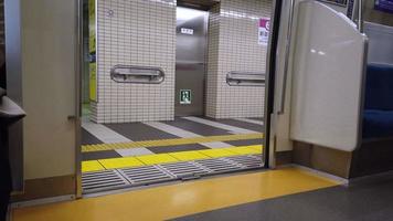 lower view to train door inside subway train commuter while door is closing