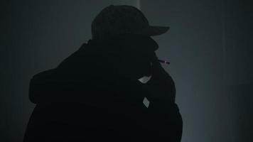 Silhouette Of Man Smoking A Cigarette And Blowing Smoke video