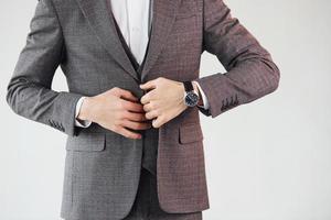 Close up view. Young stylish businessman in suit indoors. Conception of success photo